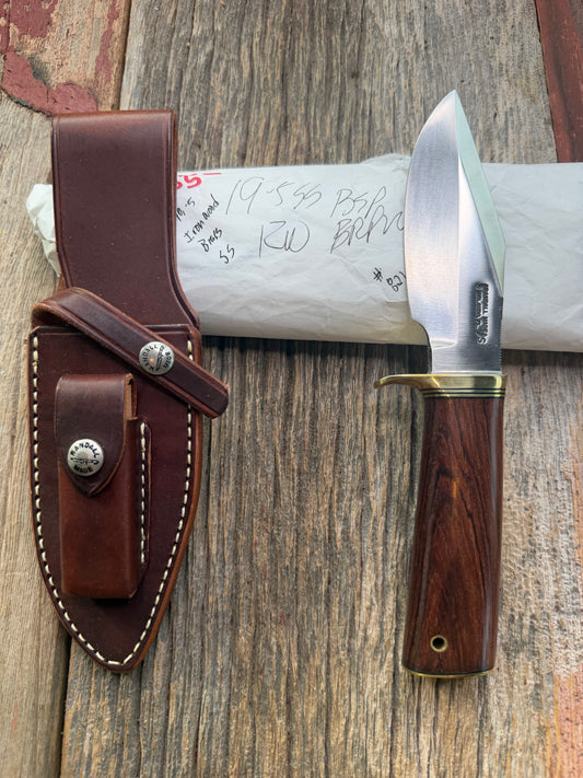 New in Paper Randall Model 19-5 with a really nice grainy piece of Ironwood. brass single Hilt , Stainless steel, Lanyard and Brass plate.