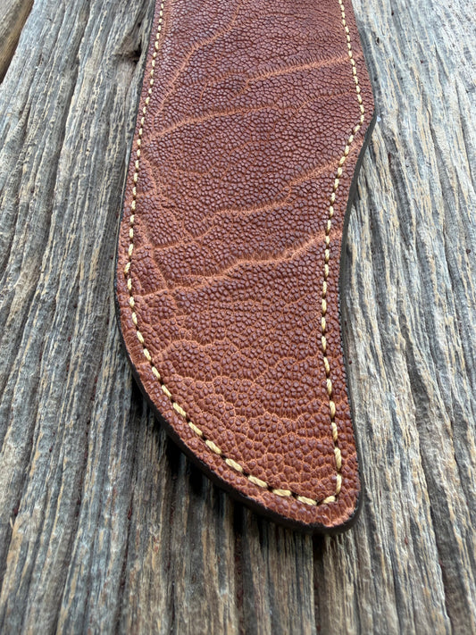 New Randall Model 12-11 Smithsonian Sheath in Exotic thick and textured Rust colored Elephant hide on brown leather from Treeman with a silver Canteen snap. Hand tooled belt loop. Killer sheath.