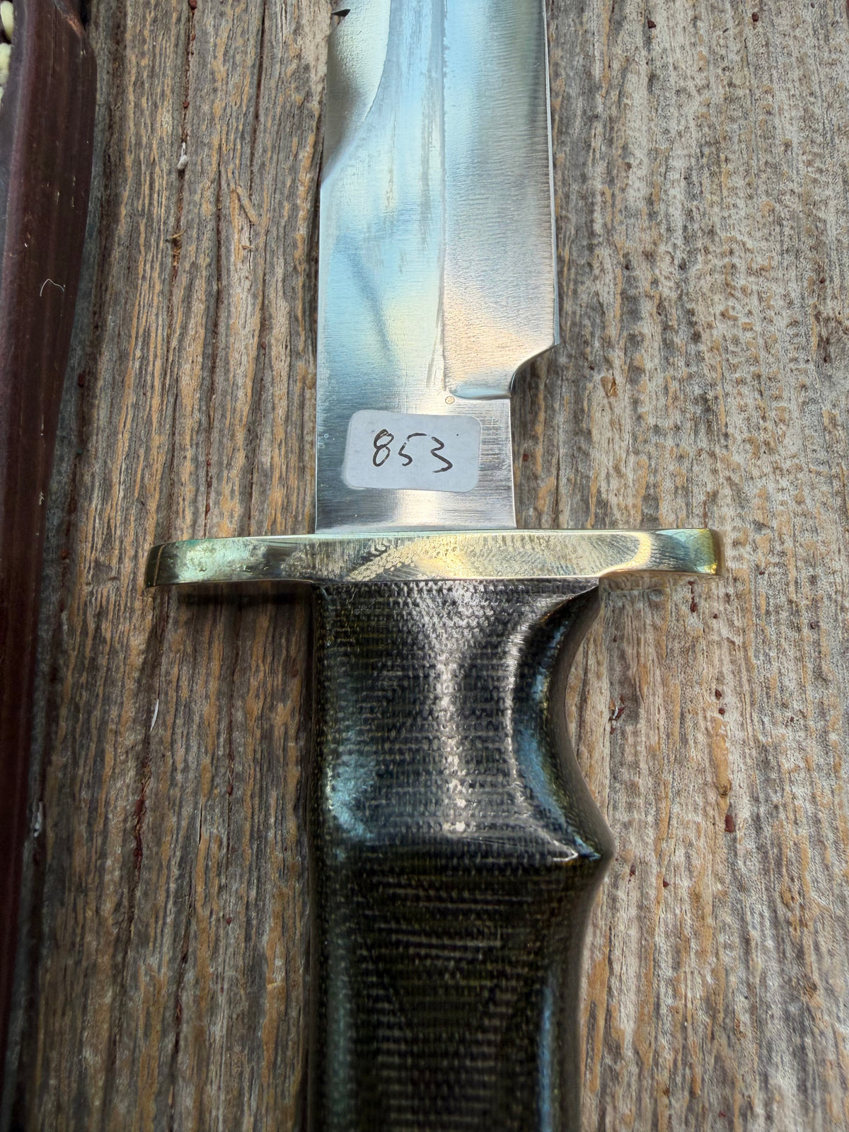 Nice Randall Model 16-7 with a glossy Brown Micarta handle. SS blade, double nickel silver hilt. Lanyard. Sawteeth, Brown waxed leather sheath.
