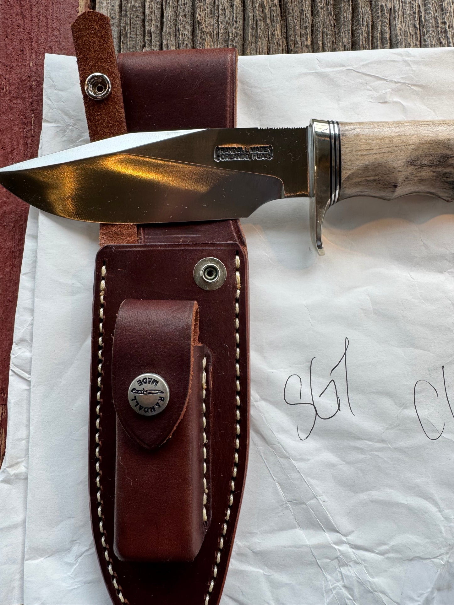 New in Paper Randall Non Catalog Model Sergeants Special, Maple handle with finger grooves. Carbon blade, Nickel silver single hilt and butt cap. Brown leather sheath.
