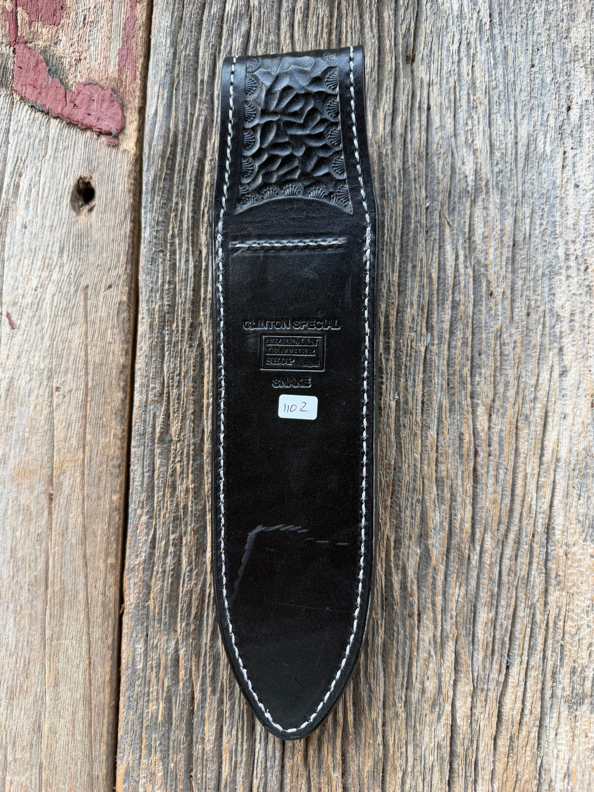 Randall Model Clinton Special sheath with inlayed Western Diamondback RattleSnake skin from Treeman Sheaths. Very dark skin on brown leather, white deviated stitching and black canteen snaps.