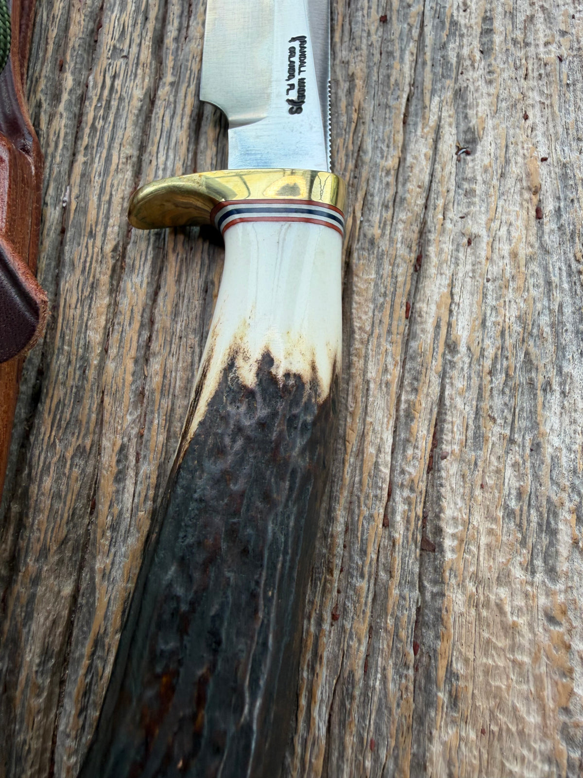 New Randall Model 5-4 with a Stag handle. Stainless steel blade, brass single hilt and natural butt. Red white and Blue spacers.