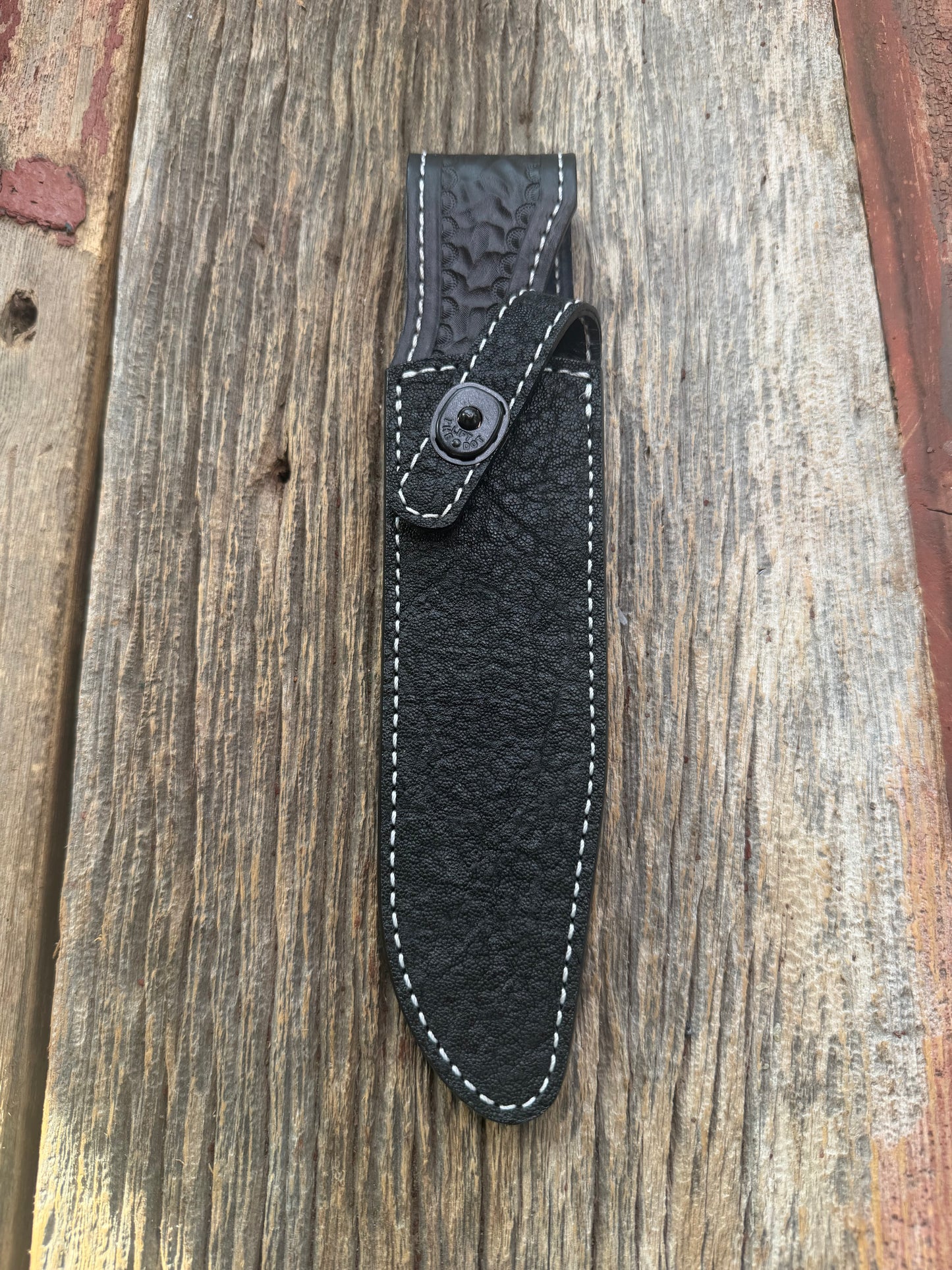 New Randall Model 1-7 Sheath in Exotic thick and textured Black Elephant hide on black leather from Treeman with a black Canteen snap. Hand tooled belt loop. Killer sheath.