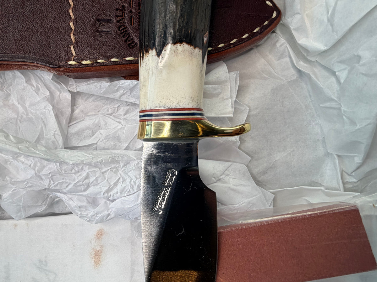New in paper Randall Model 11-3 Alaskan Skinner in Stag with a natural end. Carbon steel blade, Brass Single hilt and Brown leather sheath.