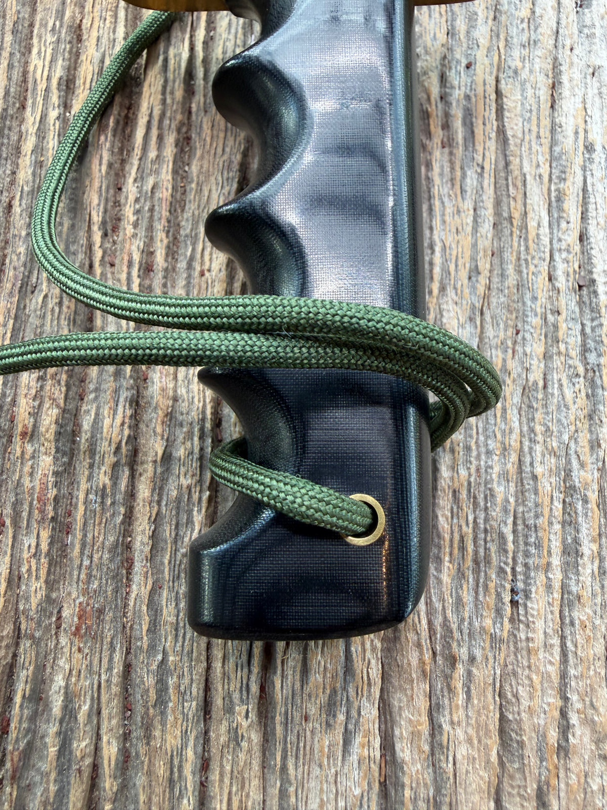 Randall Model 14-7.5 with a Black Micarta finger grooved handle. Stainless steel blade, brass double hilt brown leather sheath, Lanyard.