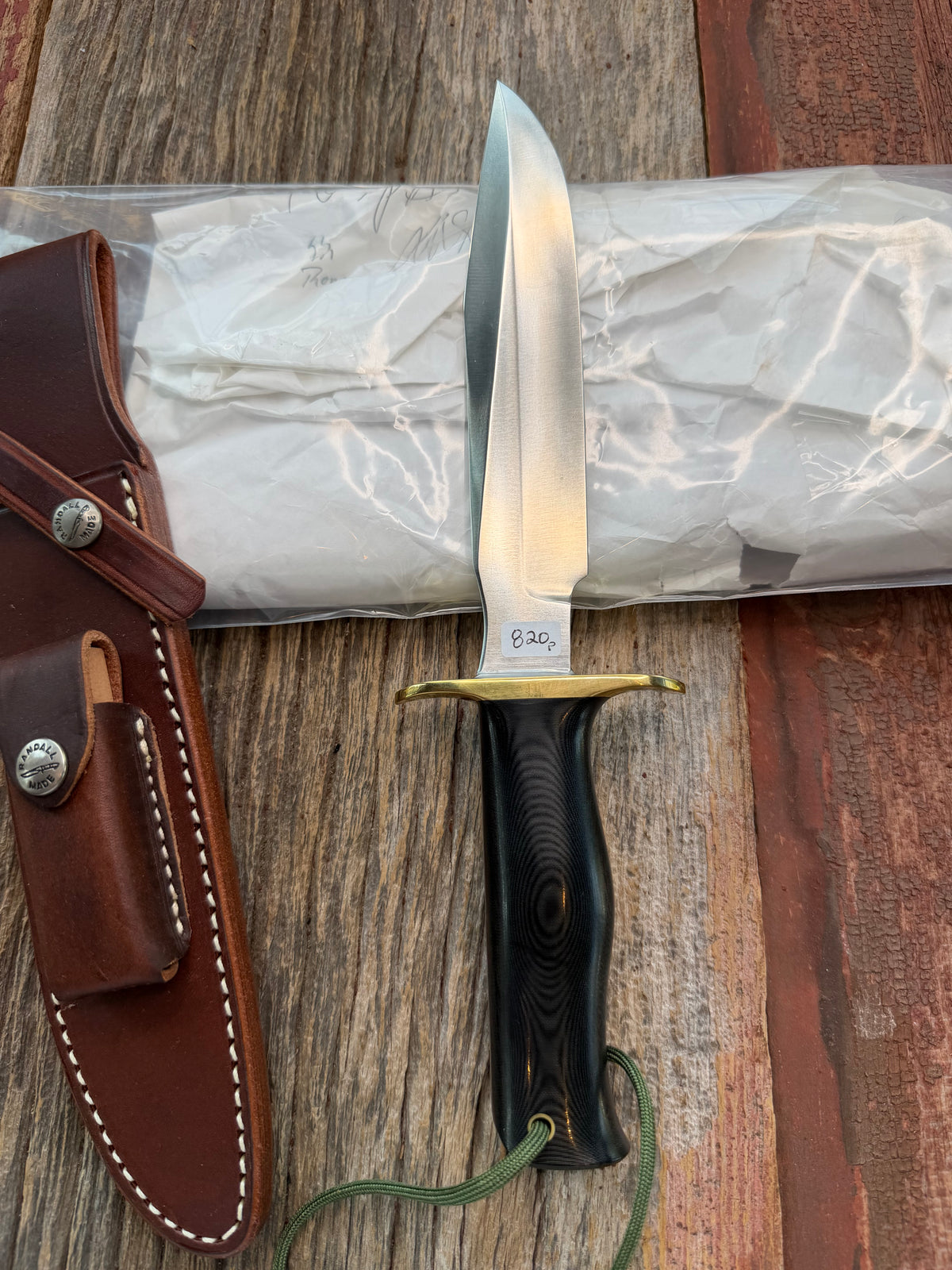 New in paper Randall Model 16 SP#1 Special fighter with a Black Micarta handle. SS blade, brass hilt. Lanyard. Brown leather sheath.