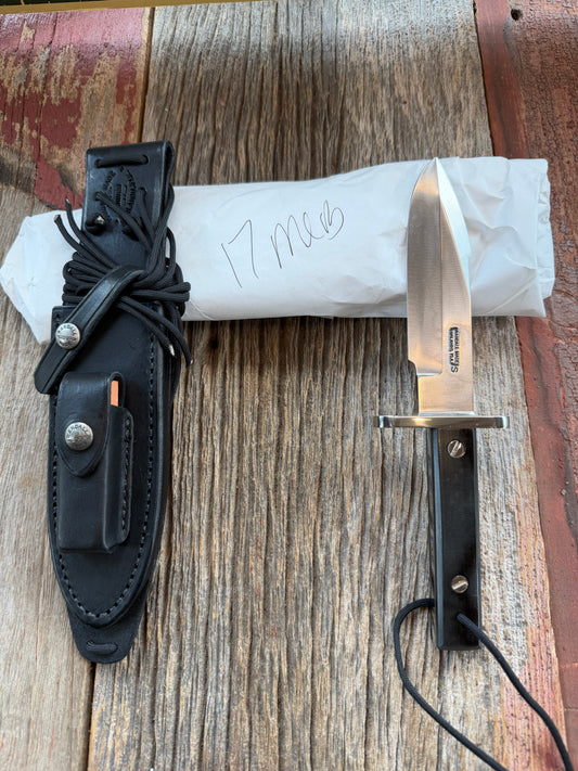 New in Paper Randall Model 17-5.5 Astro knife is a custom, handmade combat knife with a 5.5" stainless steel clip point blade and a brown leather sheath. Full tang design, black handle.
