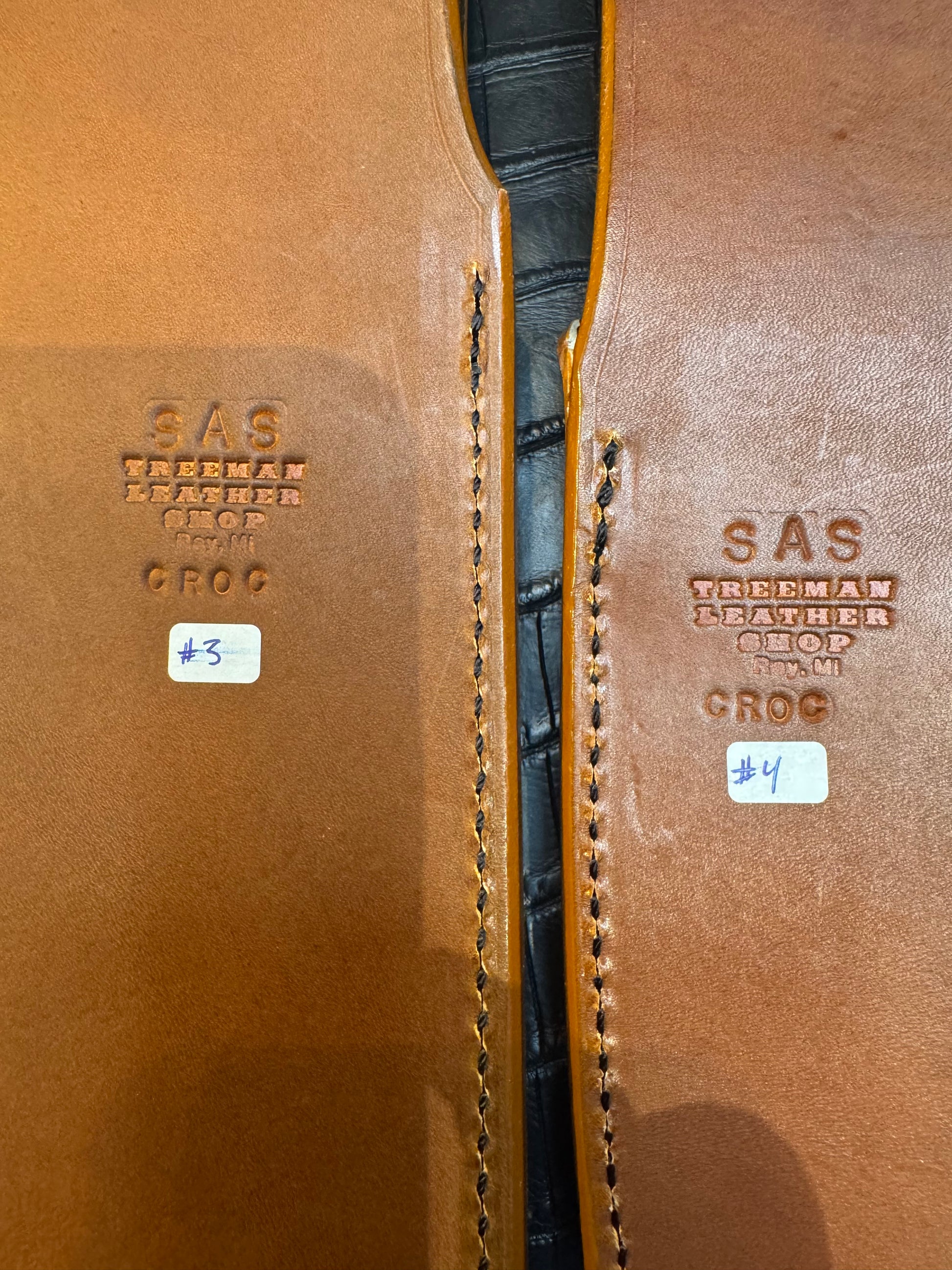 A pair of Randall Model 12-11 Large Sasquatch and Randall Model 12-8 Small Sasquatch Sheaths in Exotic Ivory Crocodile by Treeman.