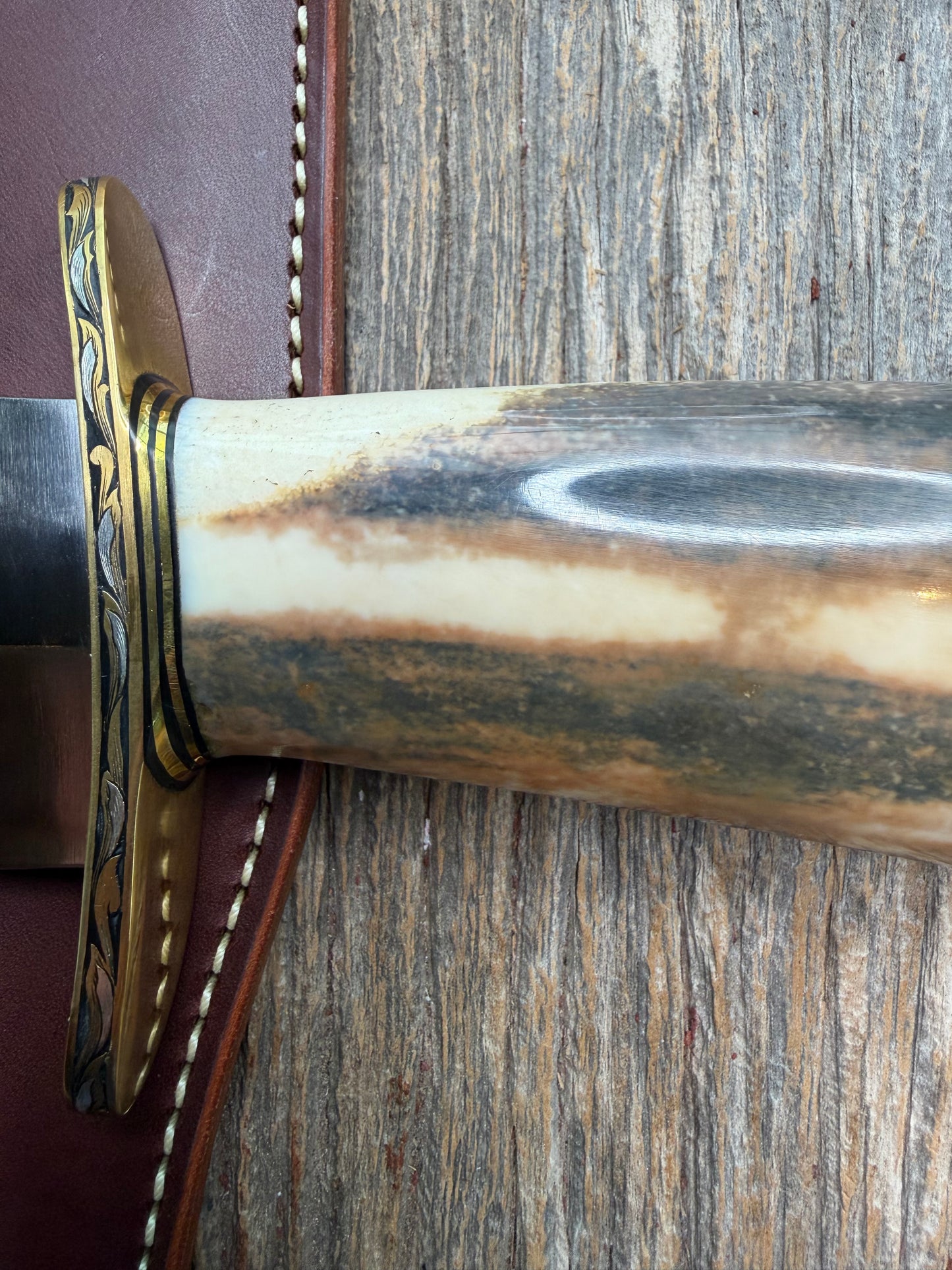 Randall Model 12-11 Smithsonian “Smitty” in a Huge piece of Green, Brown and Blue Fossil Walrus Ivory. Brass Hilt and Brass Butt plate fully engraved in Silver from Jere Davidson.  Stunning piece.