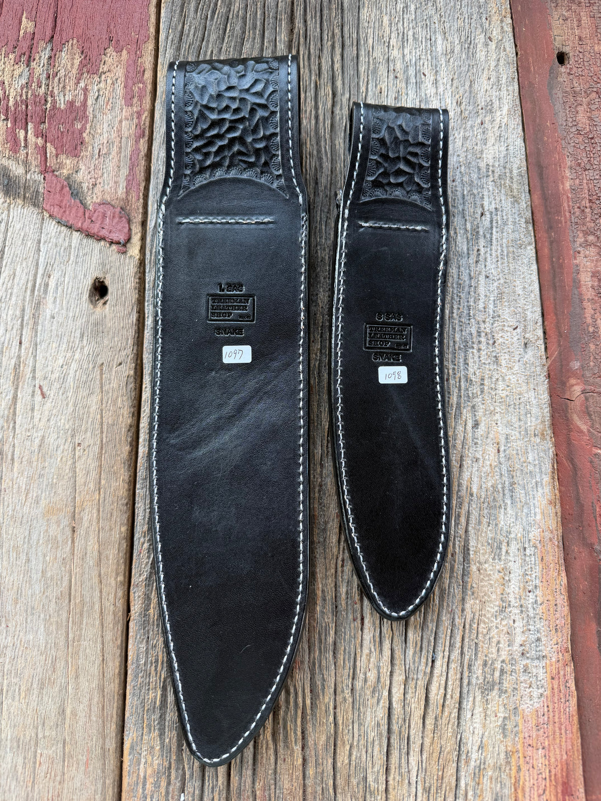 Randall Model Large Sasquatch and Small Sasquatch sheath pair with inlayed Western Diamondback RattleSnake skins from Treeman Sheaths. Very dark skins on brown leather, white deviated stitching and black canteen snaps.