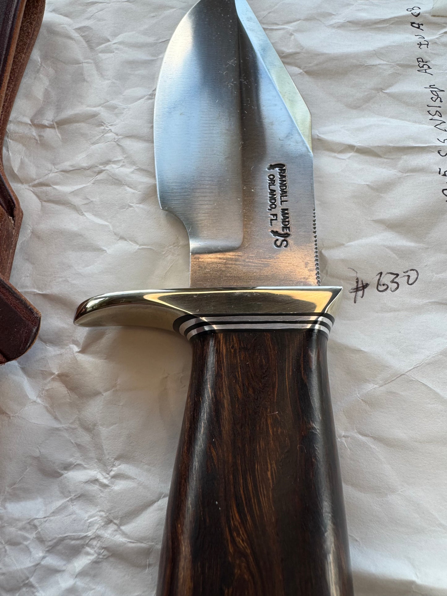 New in Paper Randall Model 19-5 Bushmaster with an Ironwood handle. SS blade, Nickel silver single hilt. Brown leather sheath.