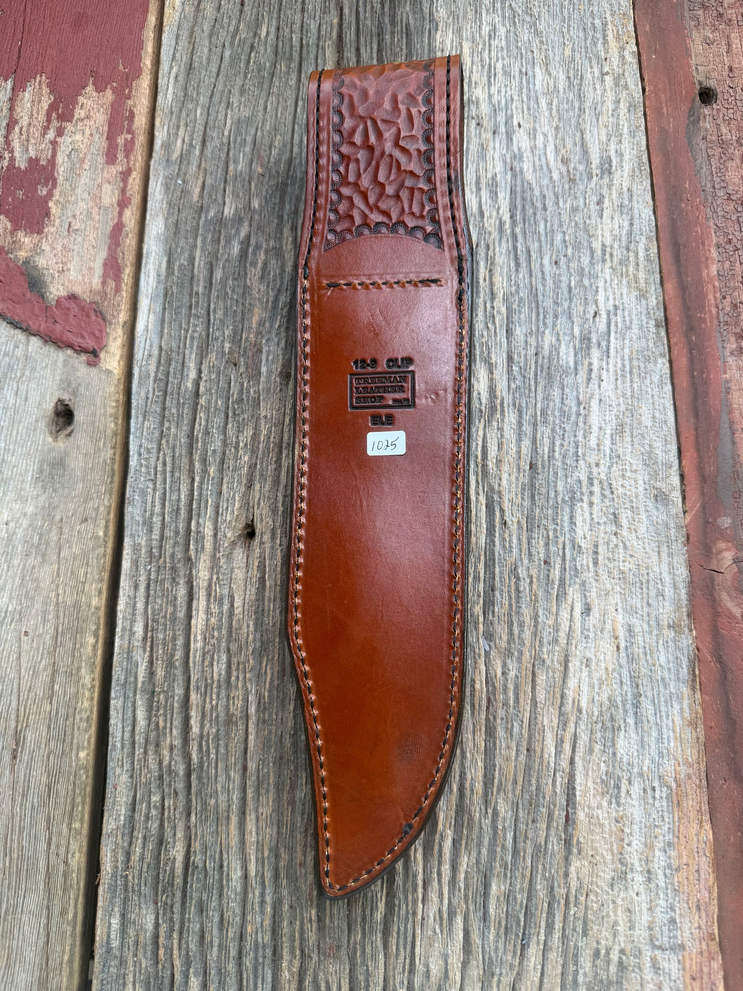 New Randall Model 12-9/14 Sheath in Exotic thick and textured Rust colored Elephant hide on brown leather from Treeman with a black Canteen snap. Hand tooled belt loop. Killer sheath.