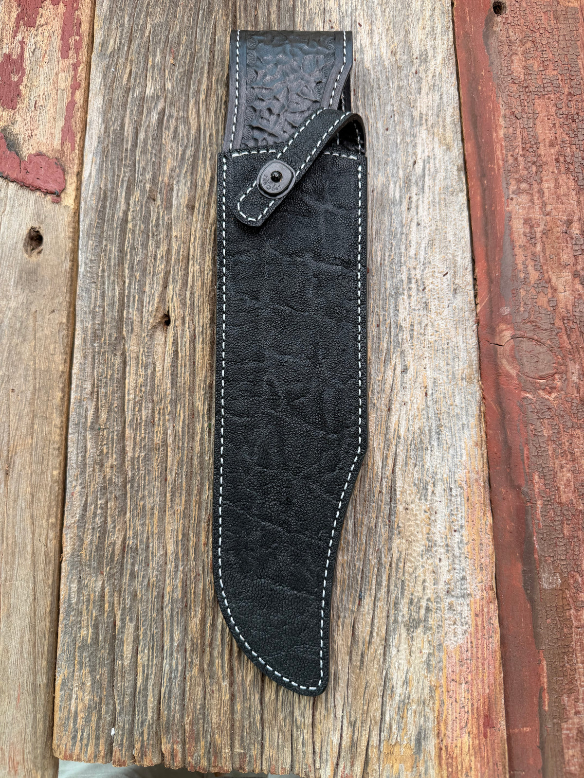 New Randall Model Smithsonian Sheath in Exotic Black Matte Elephant Hide from Treeman with a Black Canteen snap. White thread deviated stitching on black leather..Killer sheath.