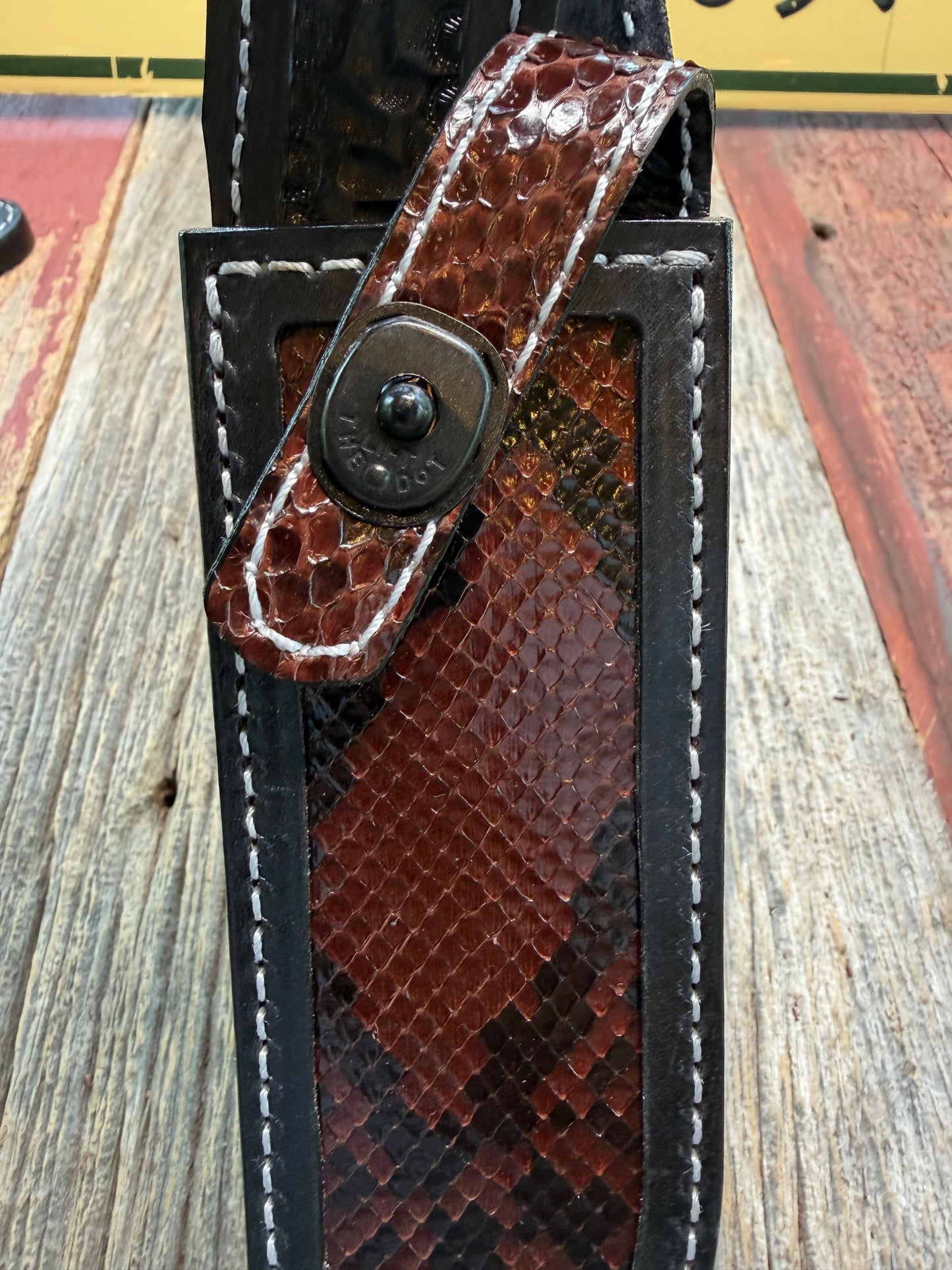 New Randall Model 1-8 Sheath in Exotic Brown Python Snake skin on black leather from Treeman with a black Canteen snap. Hand tooled belt loop. Deviated white stitching. Killer sheath.