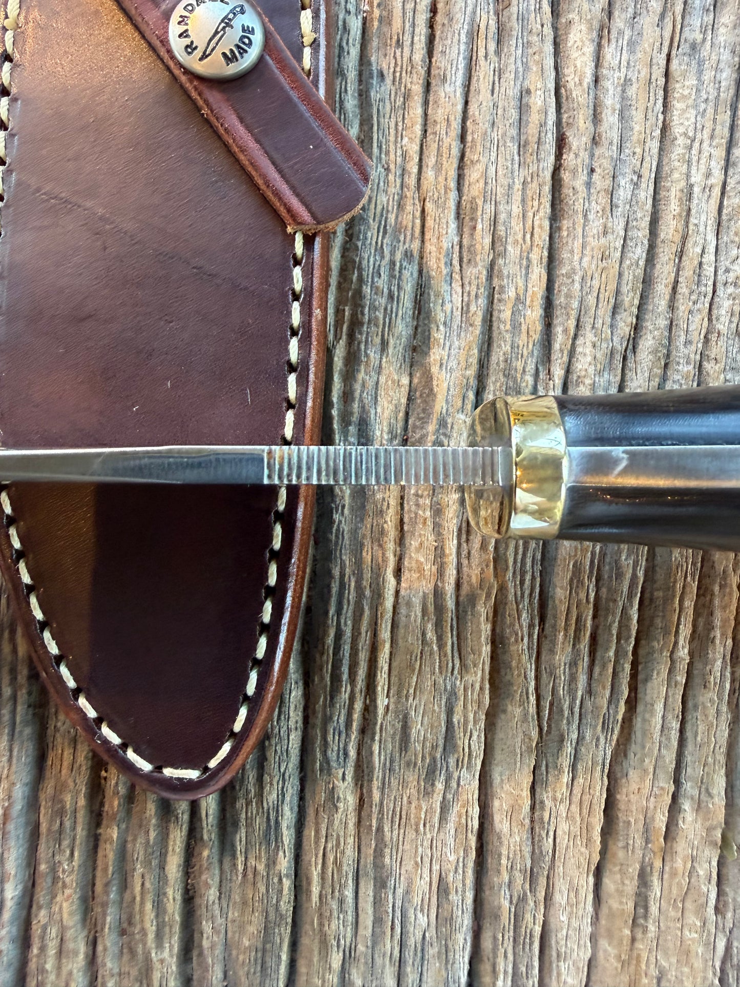 Nice Randall Model 28 Woodsman in Black Micarta. SS blade, brass single hilt. Lanyard. Brown leather sheath.