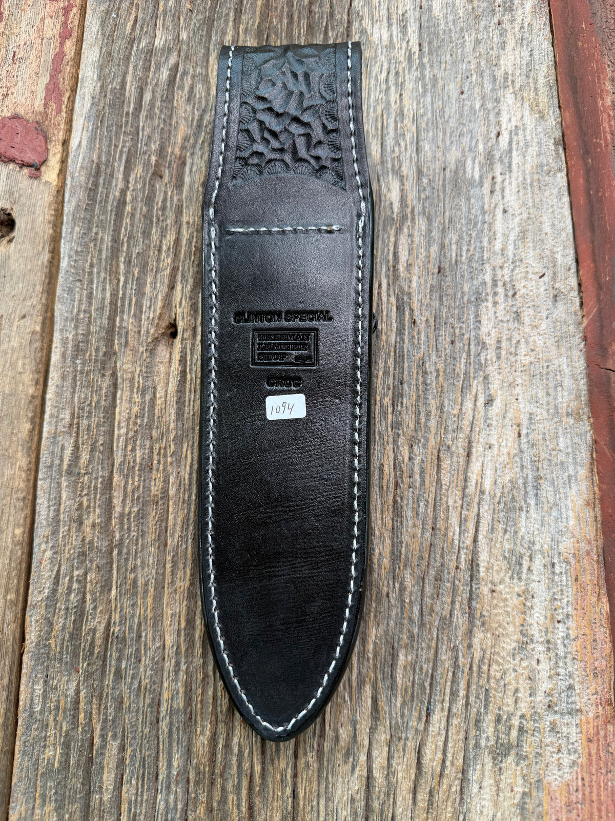 New Randall Model Clinton Special Sheath in Exotic Black Matte Crocodile tail from Treeman with a Black Canteen snap. White thread deviated stitching on black leather..Killer sheath.