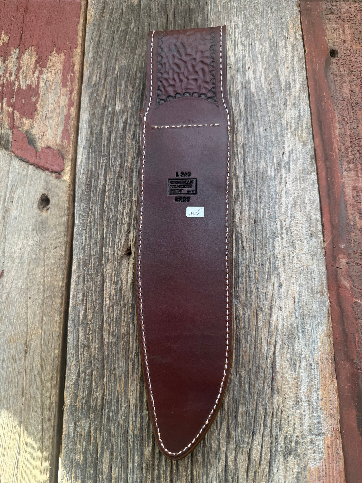 New Randall Model 12-11 Large Sasquatch Sheath in Exotic thick and textured Honey Crocodile skin ( tail portion) on brown leather from Treeman with a silver Canteen snap. Hand tooled belt loop. Killer sheath.