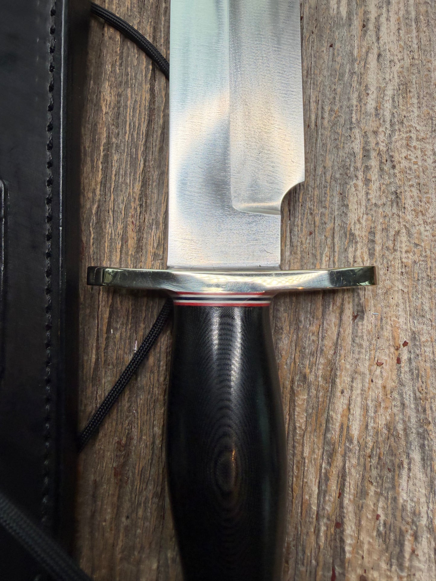 Nice Randall Model 12-9 in black Micarta handle. Red white and Blue spacers, Double Nickel Silver hilt, aluminum butt cap. Stainless blade.