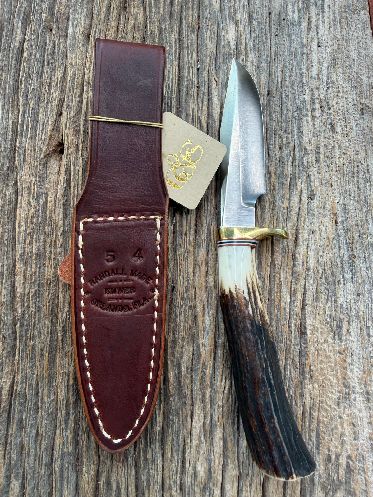 New Randall Model 5-4 with a Stag handle. Stainless steel blade, brass single hilt and natural butt. Red white and Blue spacers.