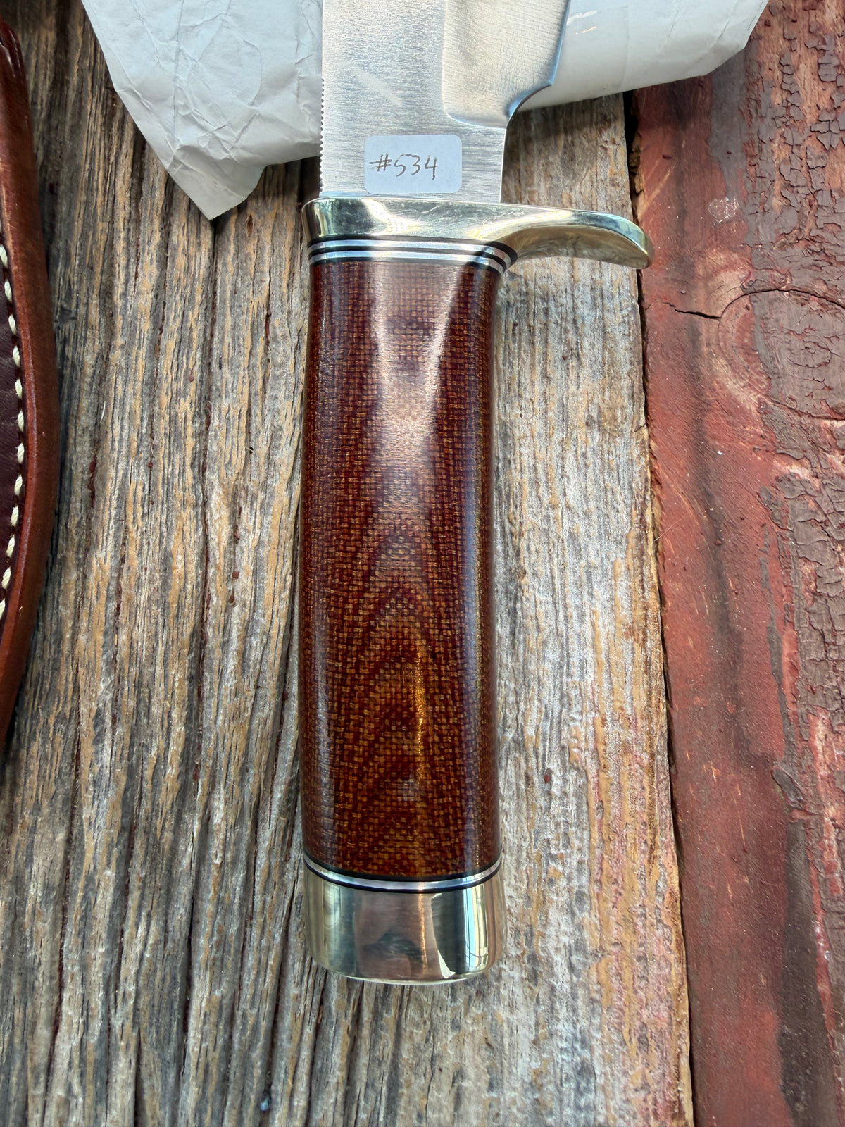 New in Paper Randall Model 19-5 with an attractive piece of Brown Micarta. Nickel silver single Hilt and buttcap , Stainless steel. Black and Aluminum spacers.