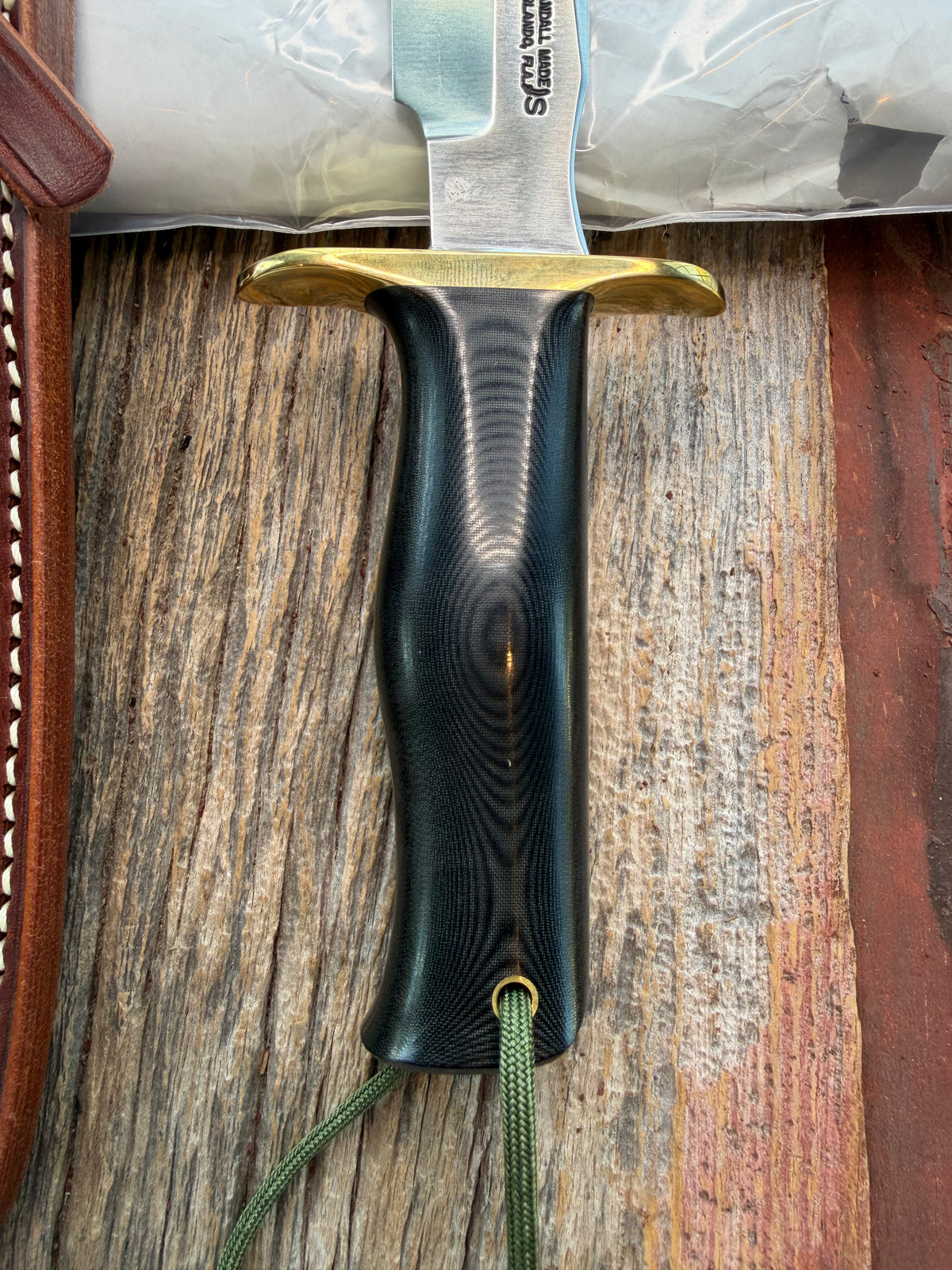 New in paper Randall Model 16 SP#1 Special fighter with a Black Micarta handle. SS blade, brass hilt. Lanyard. Brown leather sheath.
