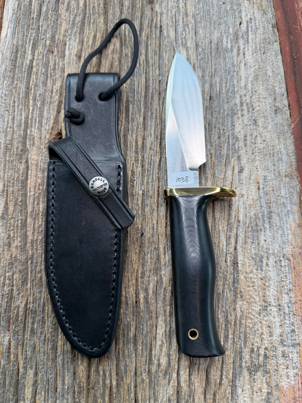 Nice Randall Model 28 Woodsman in Black Micarta. SS blade, brass single hilt. Lanyard hole. Black leather sheath.