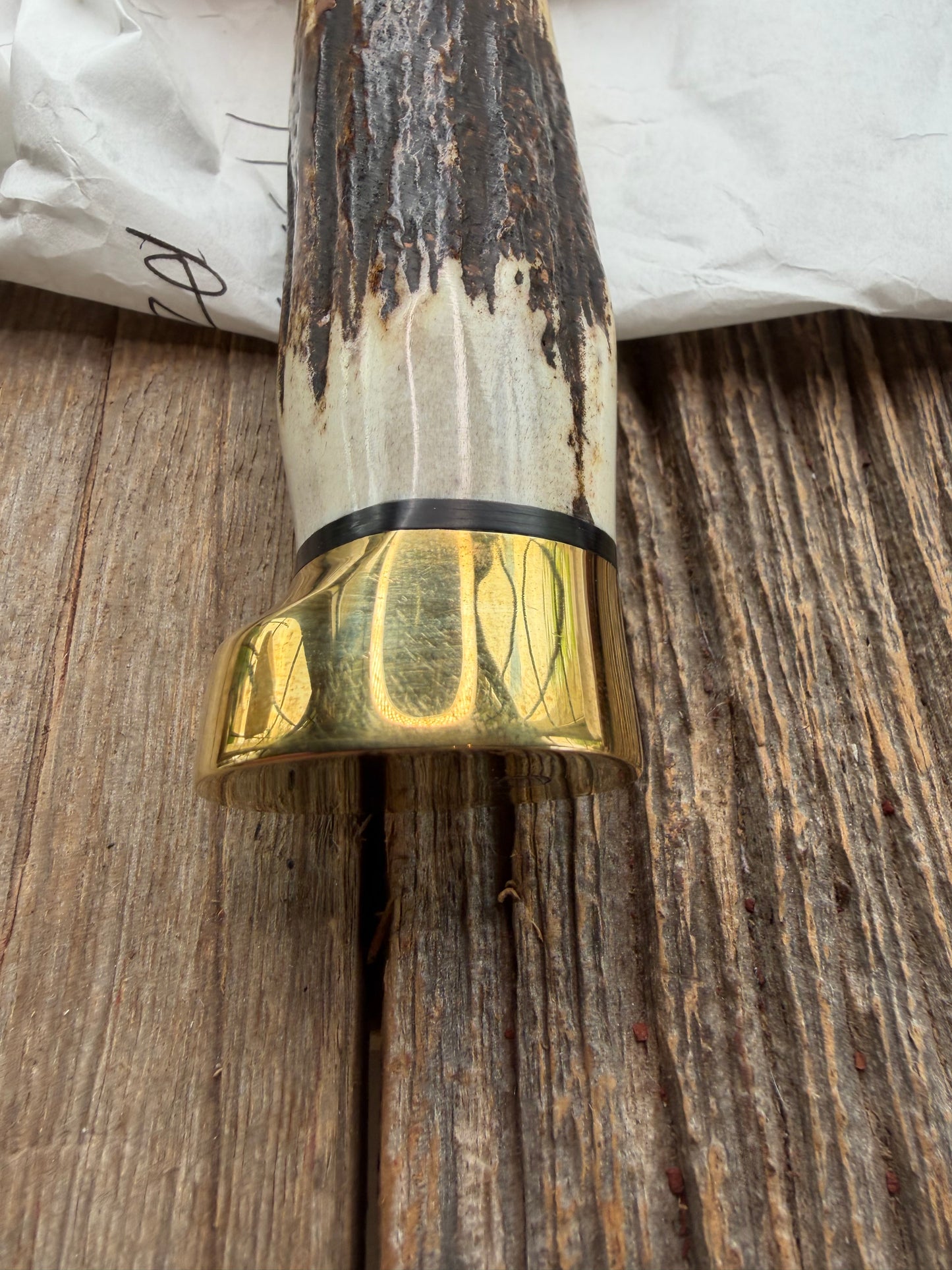 New in paper fresh from the Shop. Randall Knife Model 14-7.5 Big. Nice piece of Stag, Gorgeous Brass Lugged hilt and brass crows beak butt cap. Single black spacer. Stainless steel.