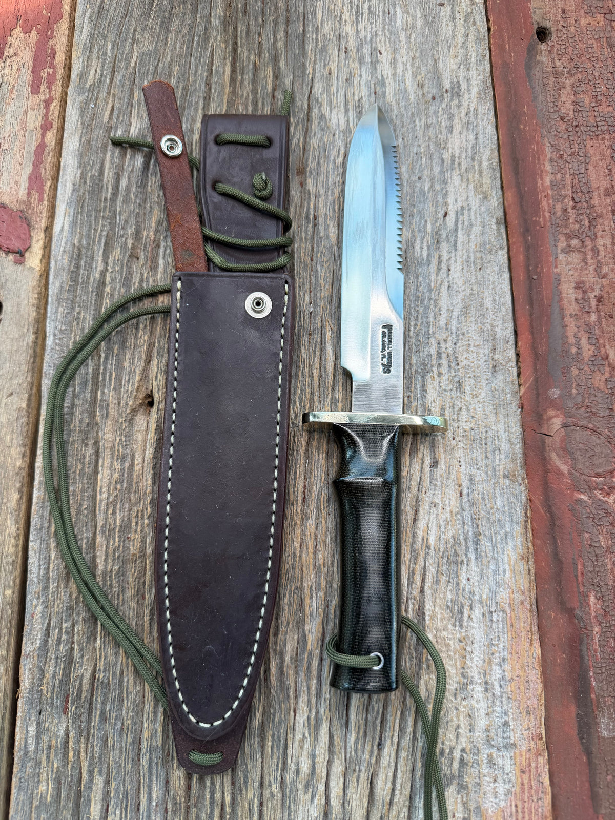 Nice Randall Model 16-7 with a glossy Brown Micarta handle. SS blade, double nickel silver hilt. Lanyard. Sawteeth, Brown waxed leather sheath.