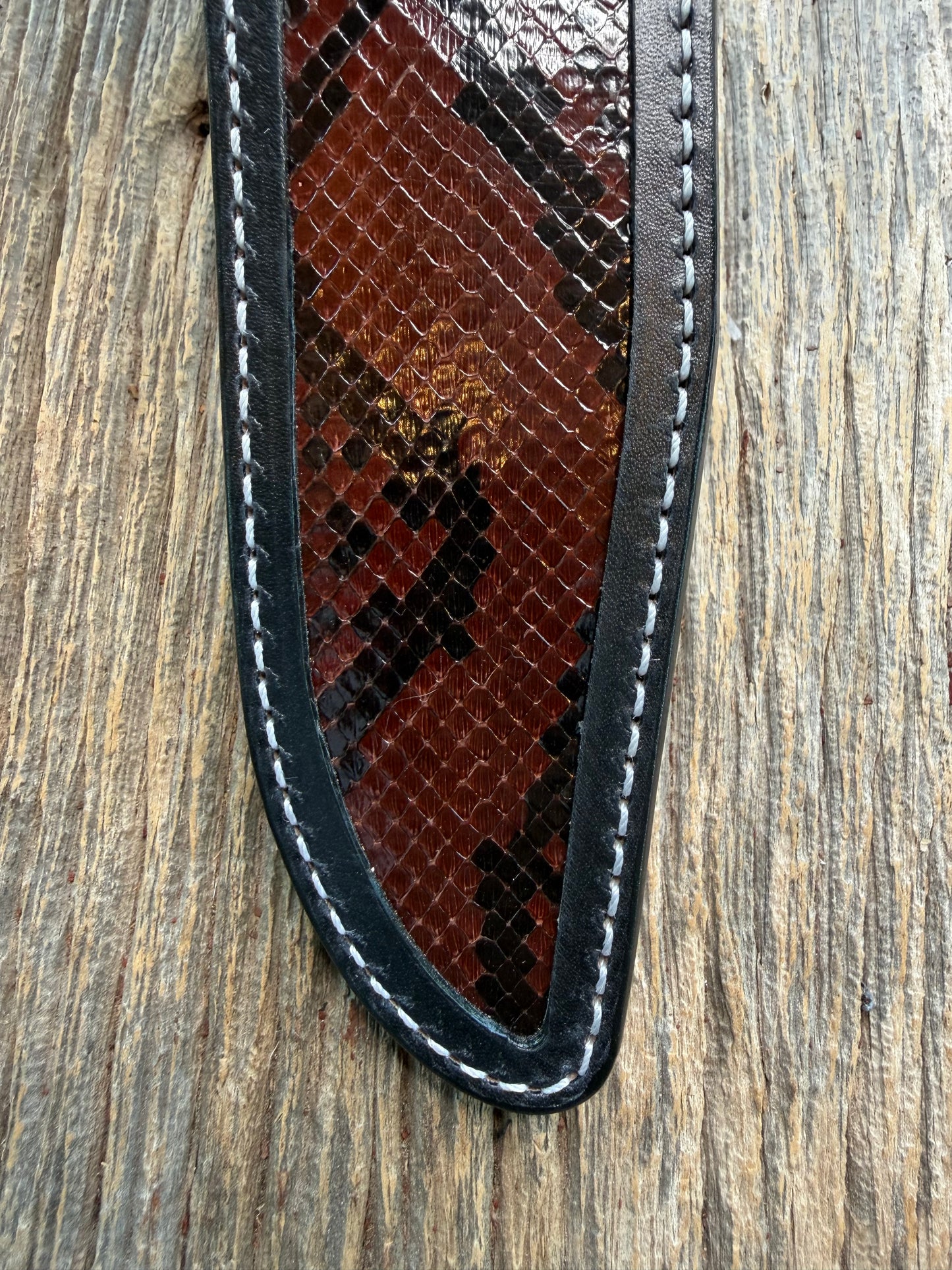 New Randall Model 1-8 Sheath in Exotic Brown Python Snake skin on black leather from Treeman with a black Canteen snap. Hand tooled belt loop. Deviated white stitching. Killer sheath.