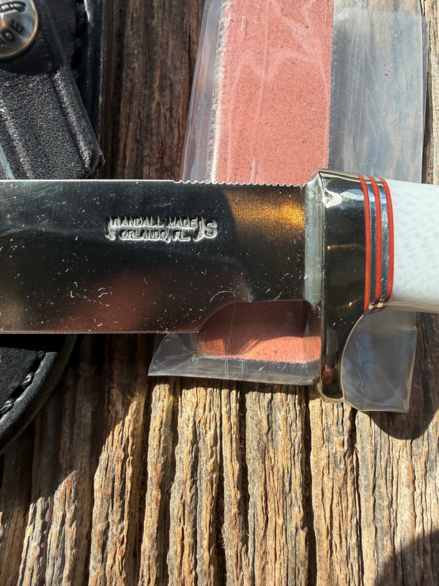 New in Paper Randall Non Catalog Model  Cattleman. White Ivorite handle. Red and silver spacers. Stainless blade.