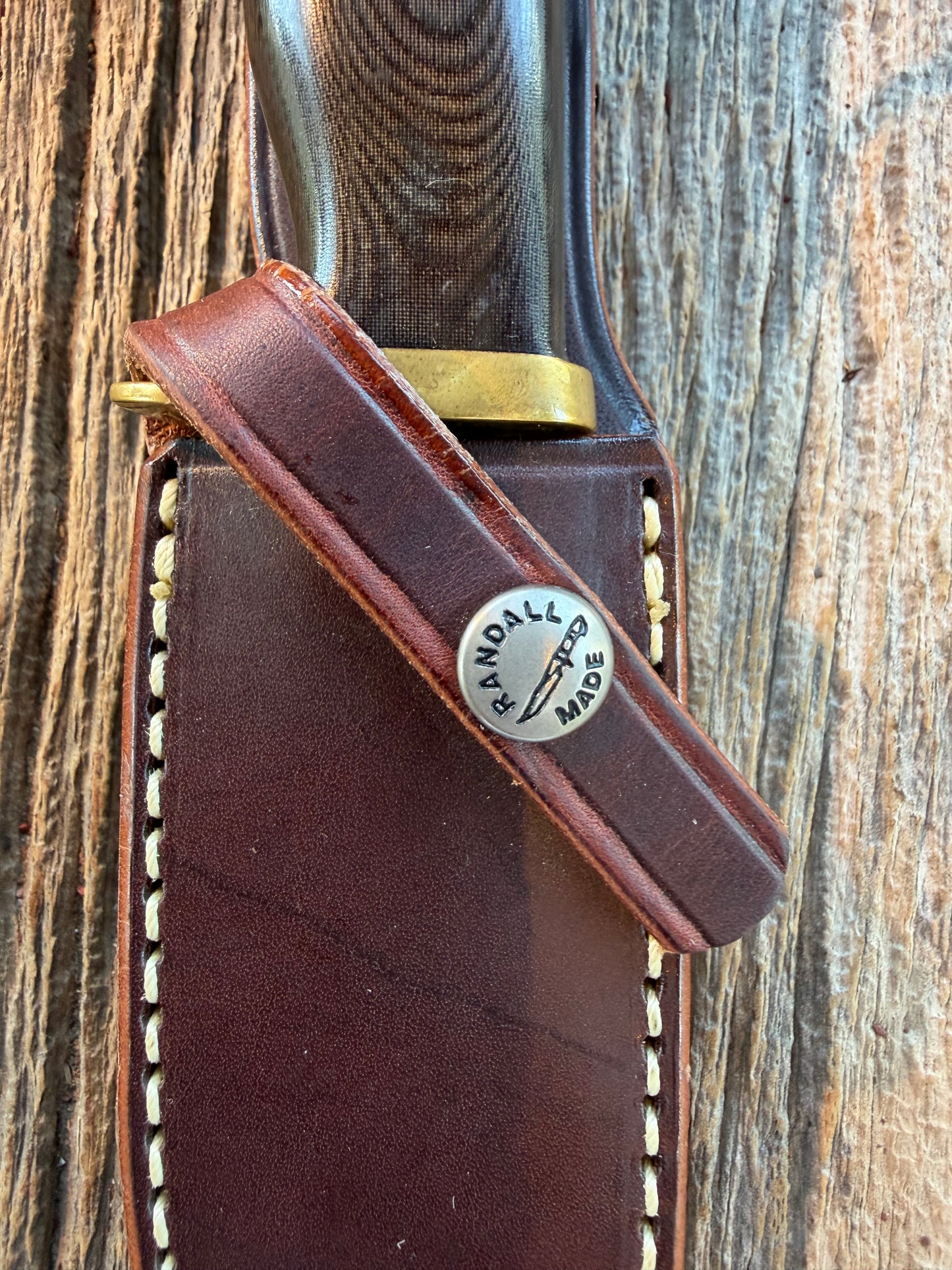 Nice Randall Model 28 Woodsman in Black Micarta. SS blade, brass single hilt. Lanyard. Brown leather sheath.