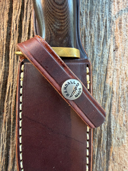 Nice Randall Model 28 Woodsman in Black Micarta. SS blade, brass single hilt. Lanyard. Brown leather sheath.