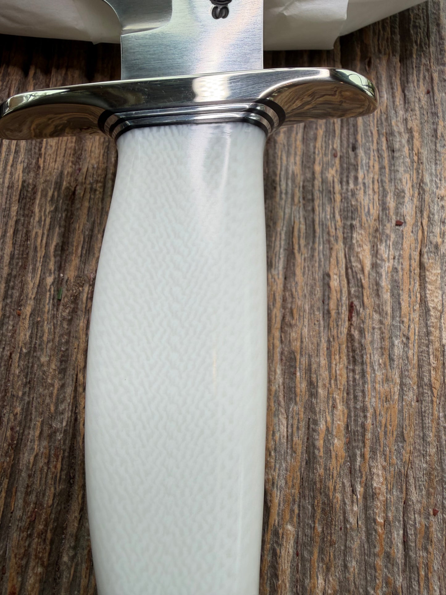 New in Paper Randall Model 19-5 Bushmaster with a White Ivorite handle. Stainless steel blade, Nickel silver hilt. Upgraded Black leather sheath. Crows Beak Aluminum handle.