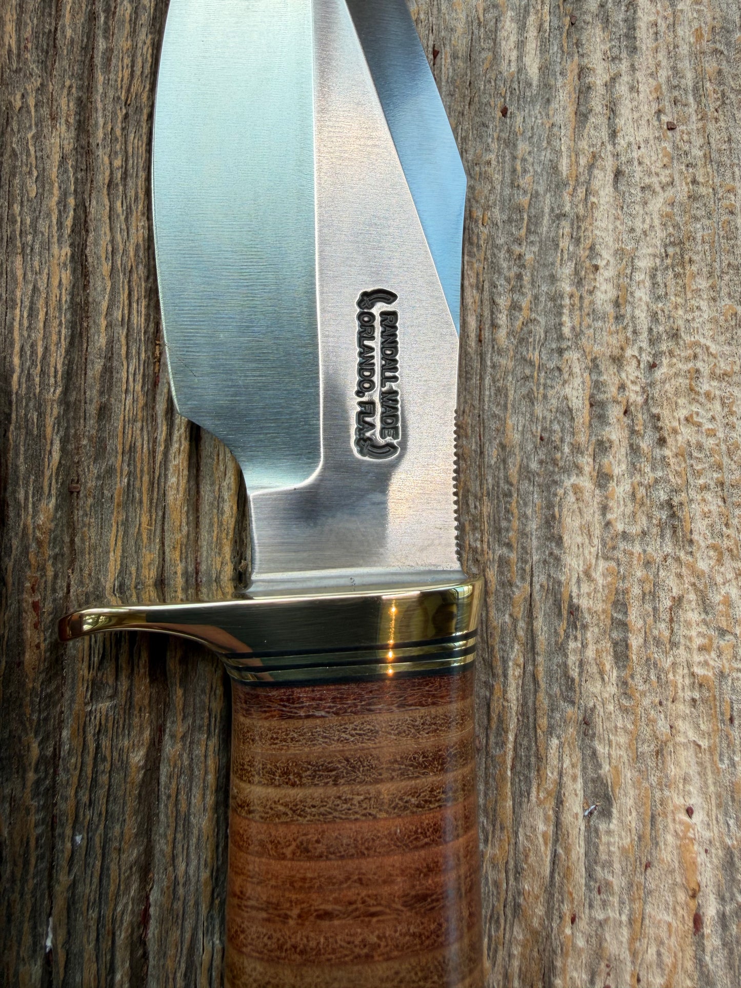 New Randall Model 19-5 Bushmaster with a Leather handle. Carbon blade, Brass single hilt. Brown leather sheath.