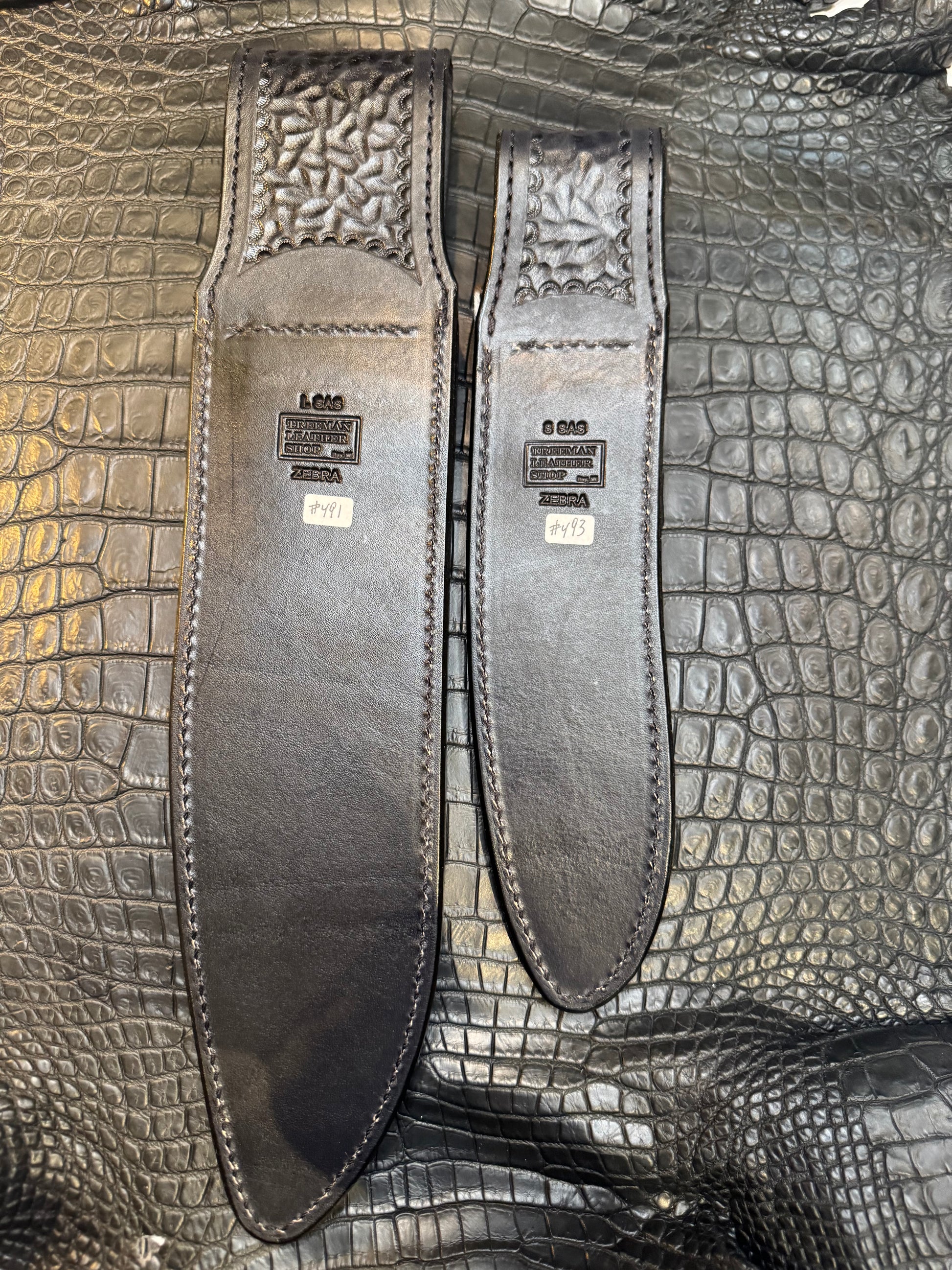 A pair of Randall Model 12-11 Large Sasquatch and Randall Model 12-8 Small Sasquatch Sheaths in Exotic Zebra by Treeman.