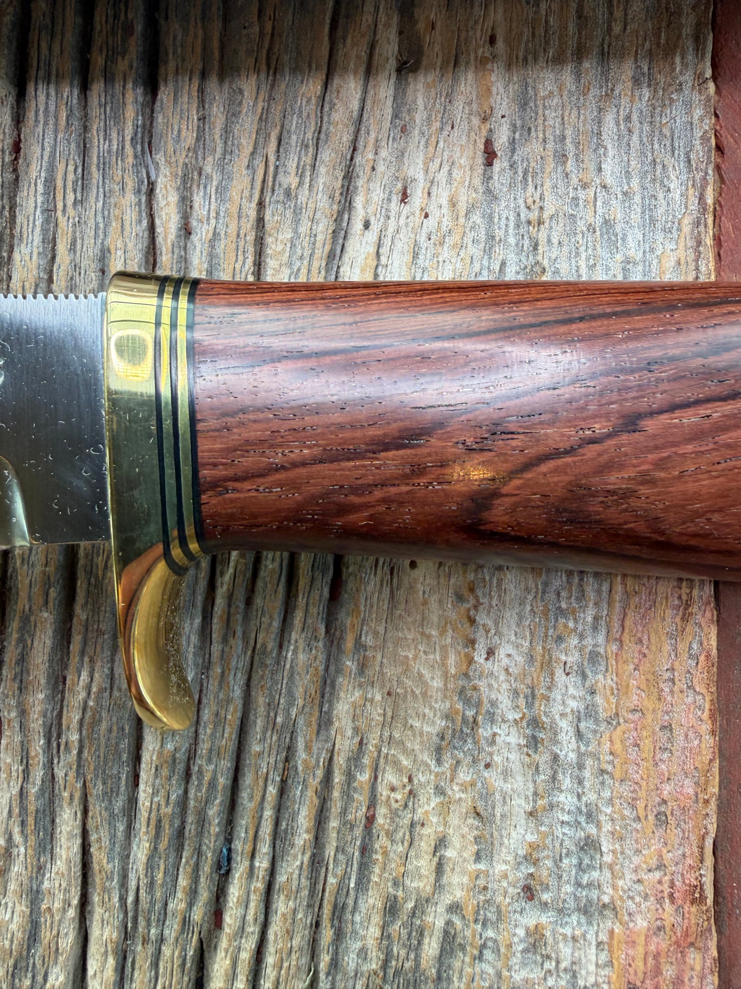 New in Paper Randall Model 19-5 with a really nice grainy piece of Ironwood. brass single Hilt , Stainless steel, Lanyard and Brass plate.