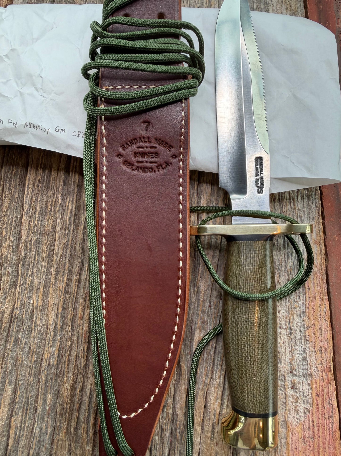 New in Paper Randall Made Knife Model 1-7 Green Micarta handle, Stainless, brass Double Hilt, Brass Crows beak butt cap, lanyard, Sawteeth, single black spacer…loaded!!