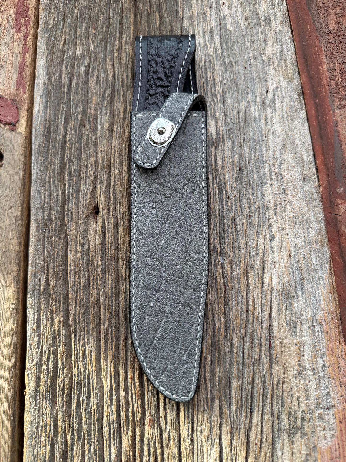 New Randall Model 1-8 Sheath in Exotic thick and textured Grey Elephant Hide on black leather from Treeman with a silver Canteen snap. Hand tooled belt loop. Killer sheath.