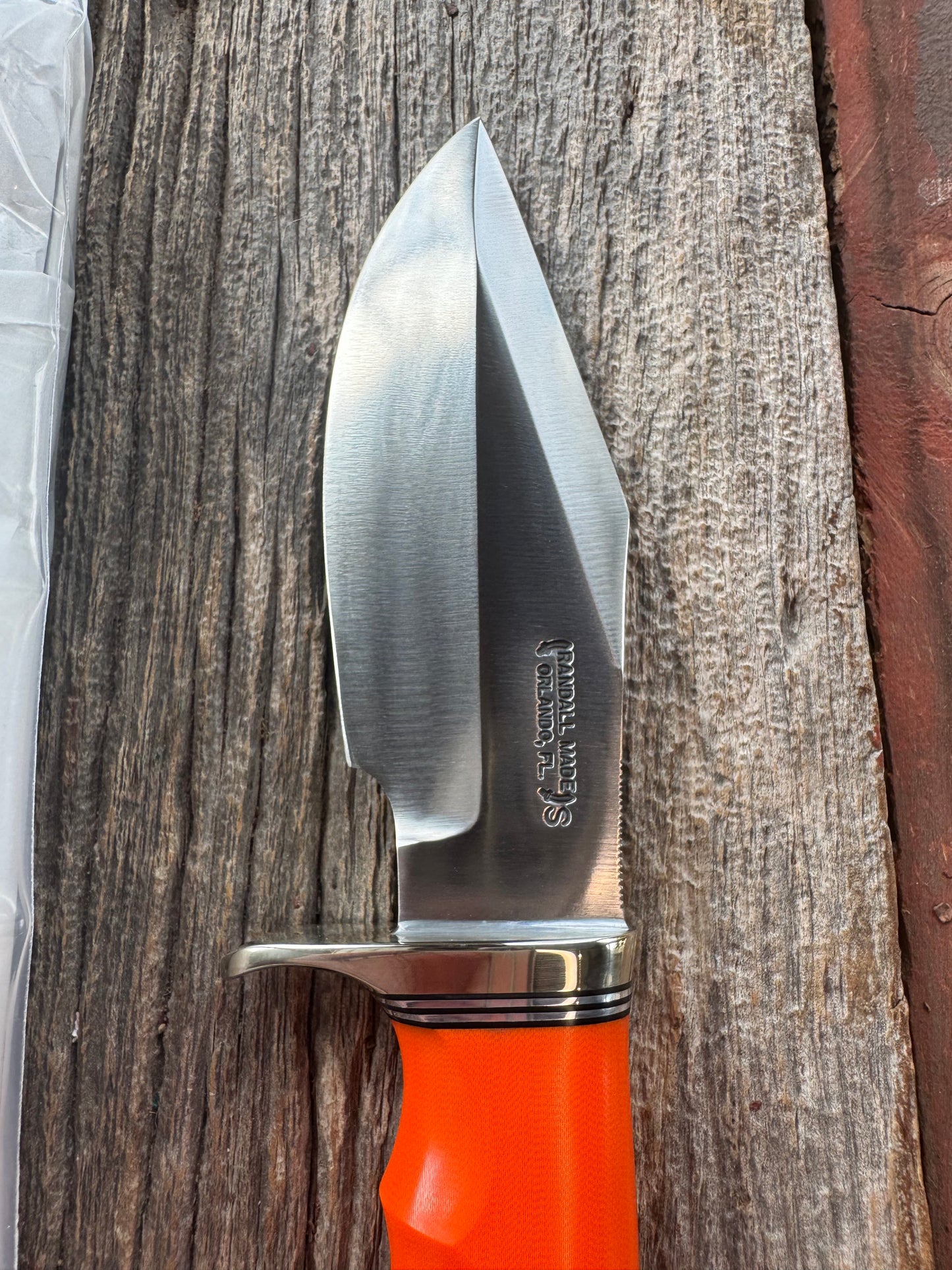 New in paper Randall Model 19-5 with a nice piece of customer supplied Orange G10 with finger grooves. Stainless Steel, Nickel Silver Hilt and a raw natural end.
