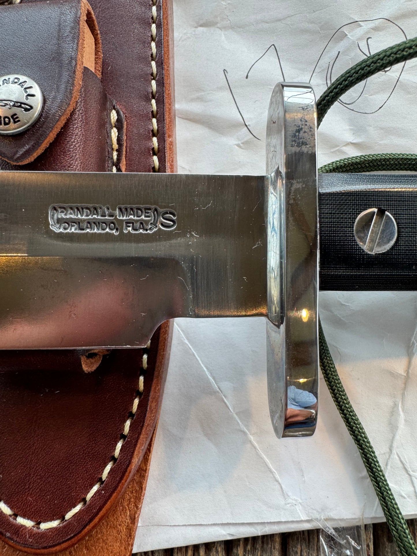 New in Paper Randall Model 17-5.5 Astro knife is a custom, handmade combat knife with a 5.5" stainless steel clip point blade and a brown leather sheath. Full tang design, black handle.