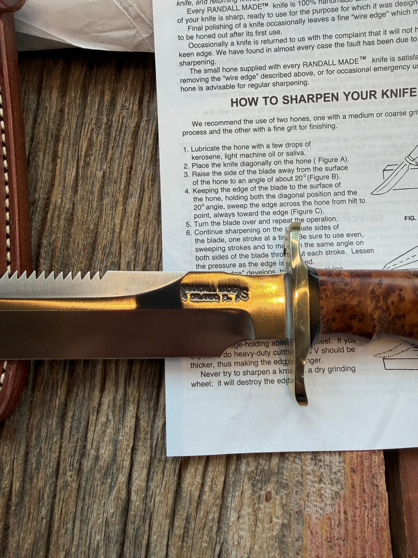 New in Paper Randall Made Knife Model 1-8 in Thuya wood. Stainless, single Black spacer, Sawteeth, Nickel Hilt.
