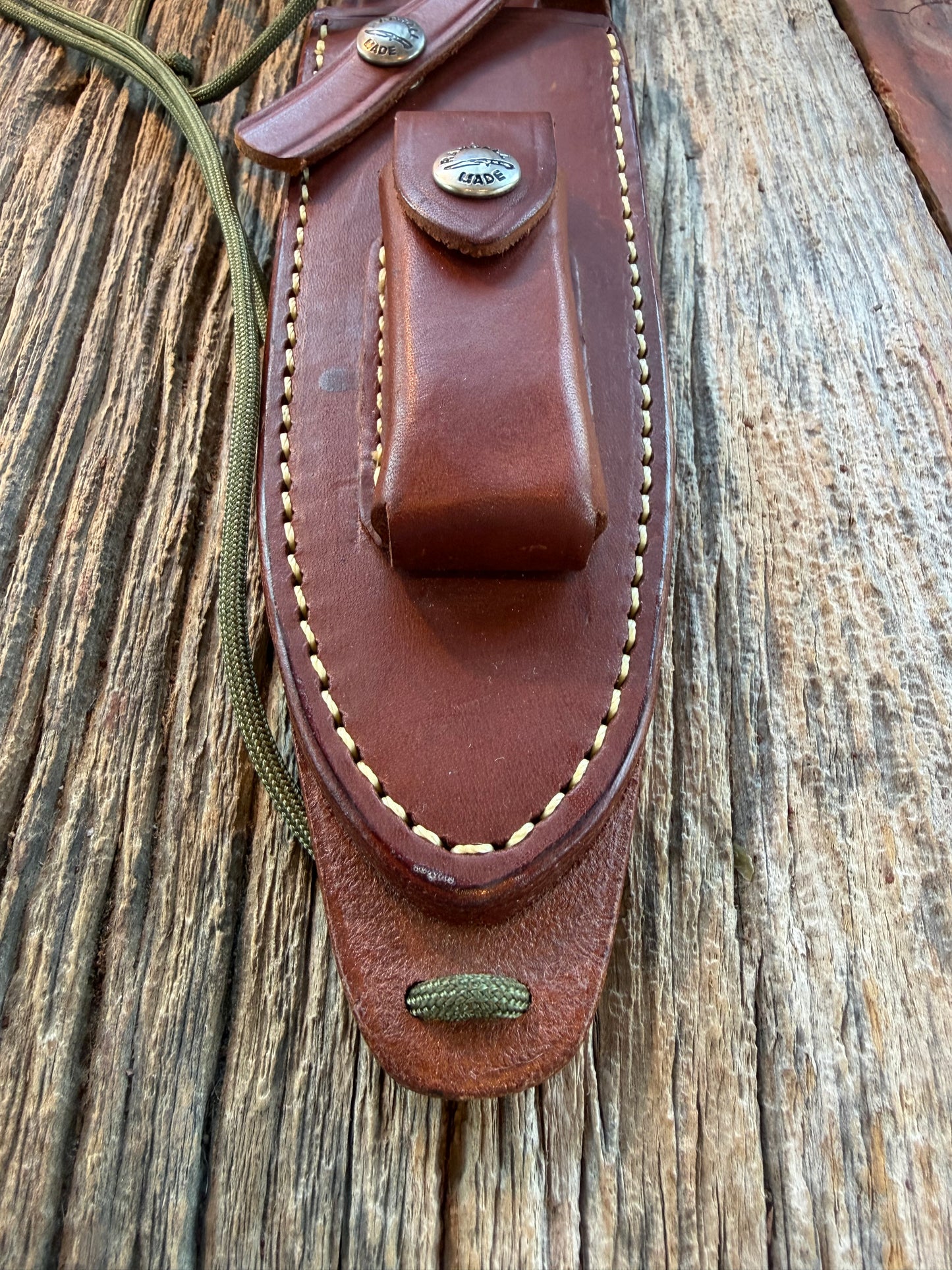 Mint Randall by Gutcher Knife Sheath for a Model Buxton Fighter. Randall snaps, double stitched, pouch with stone, lanyards straps as well.