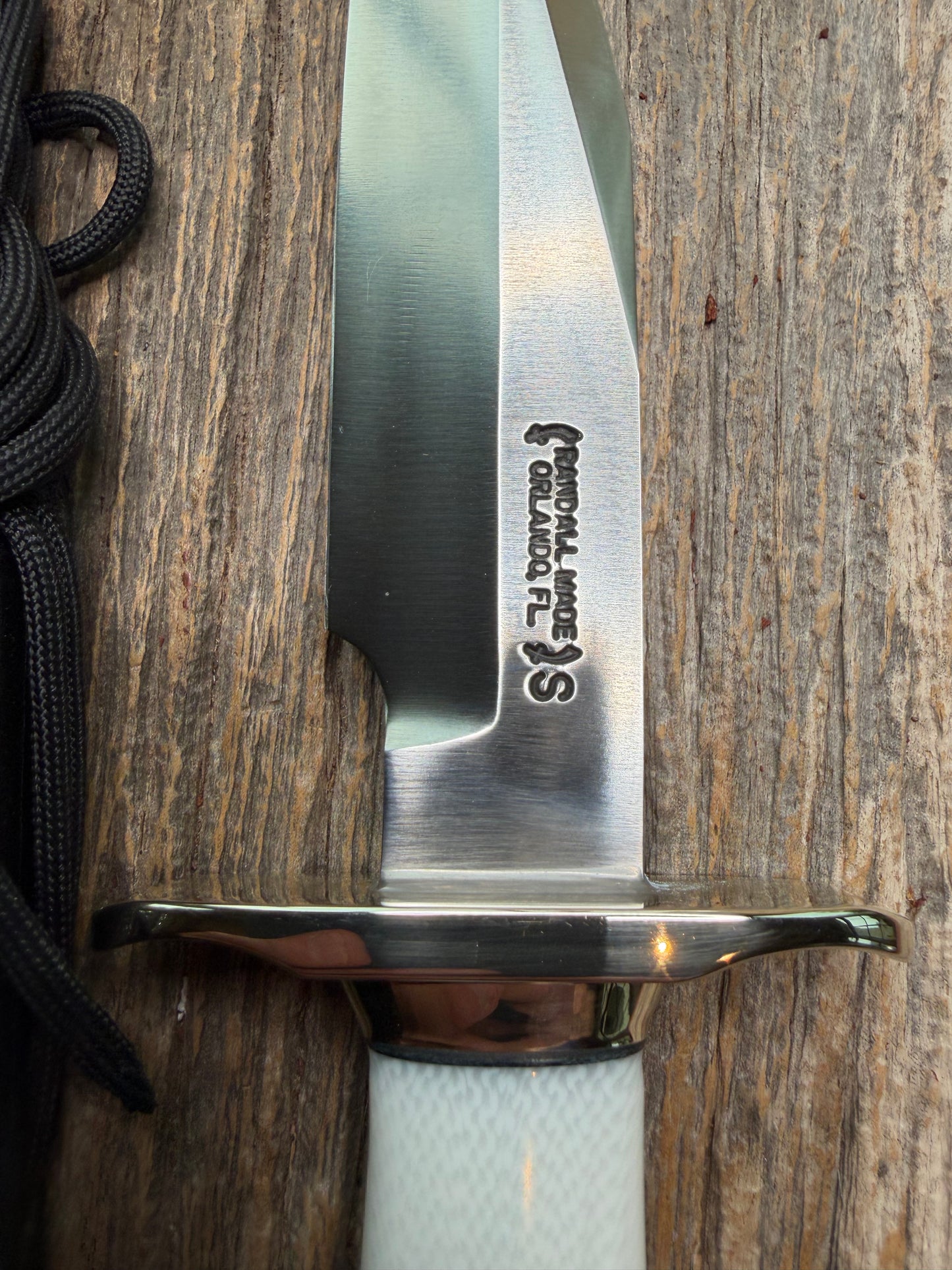 Randall Model 15 with a White Ivorite handle. Stainless steel blade, Nickel silver hilt and collar. Upgraded Black leather sheath.  Roundsd Aluminum butt cap.