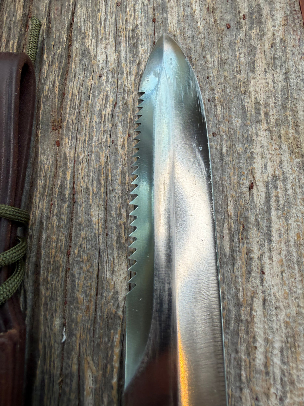 Nice Randall Model 16-7 with a glossy Brown Micarta handle. SS blade, double nickel silver hilt. Lanyard. Sawteeth, Brown waxed leather sheath.
