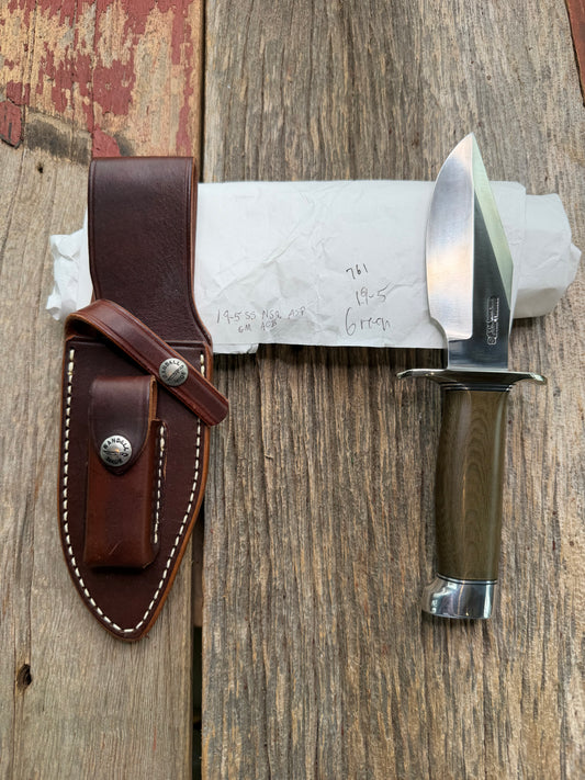 New in Paper Randall Model 19-5 Bushmaster with a Green Micarta handle. Stainless steel blade, Nickel silver hilt. Brown leather sheath. Crows Beak Aluminum handle.