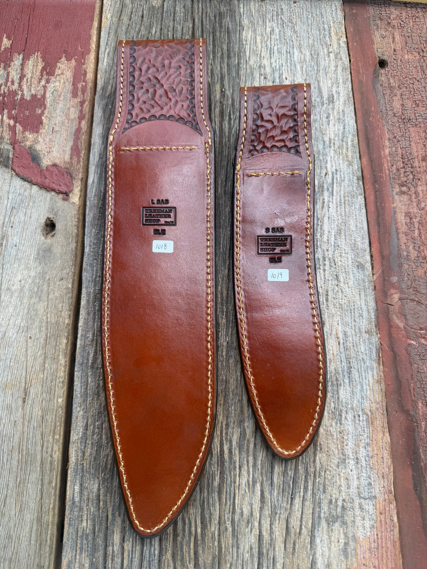 New Randall Model 12-11 Large Sasquatch and 12-8 Small Sasquatch Sheaths in Exotic thick and textured Rust colored Elephant hide on brown leather from Treeman with silver Canteen snaps. Hand tooled belt loop. Killer sheath. Selling as a pair…