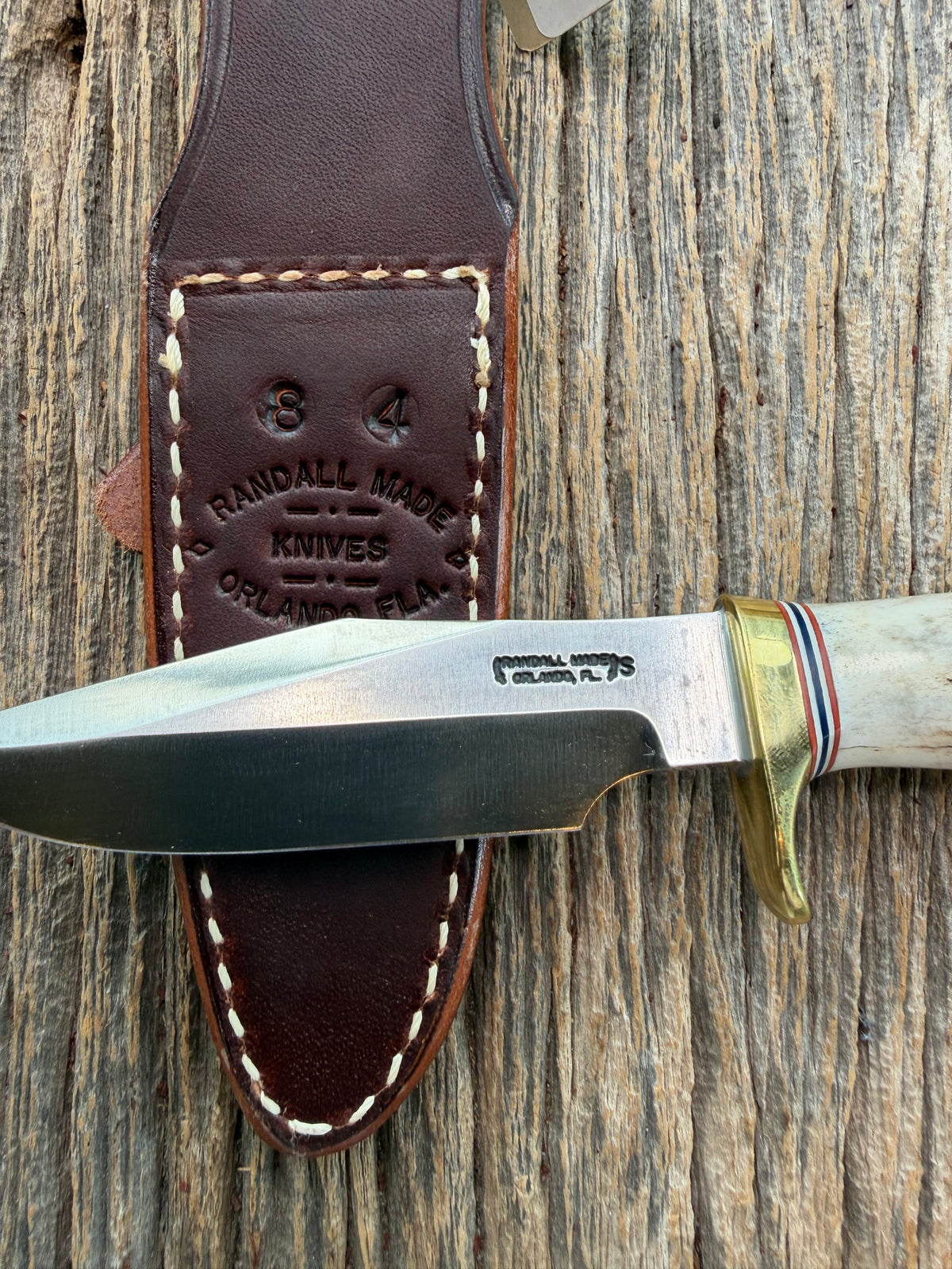 New Randall Model 8-4 with a Stag handle. Stainless steel blade, brass single hilt and natural butt. Red white and Blue spacers.