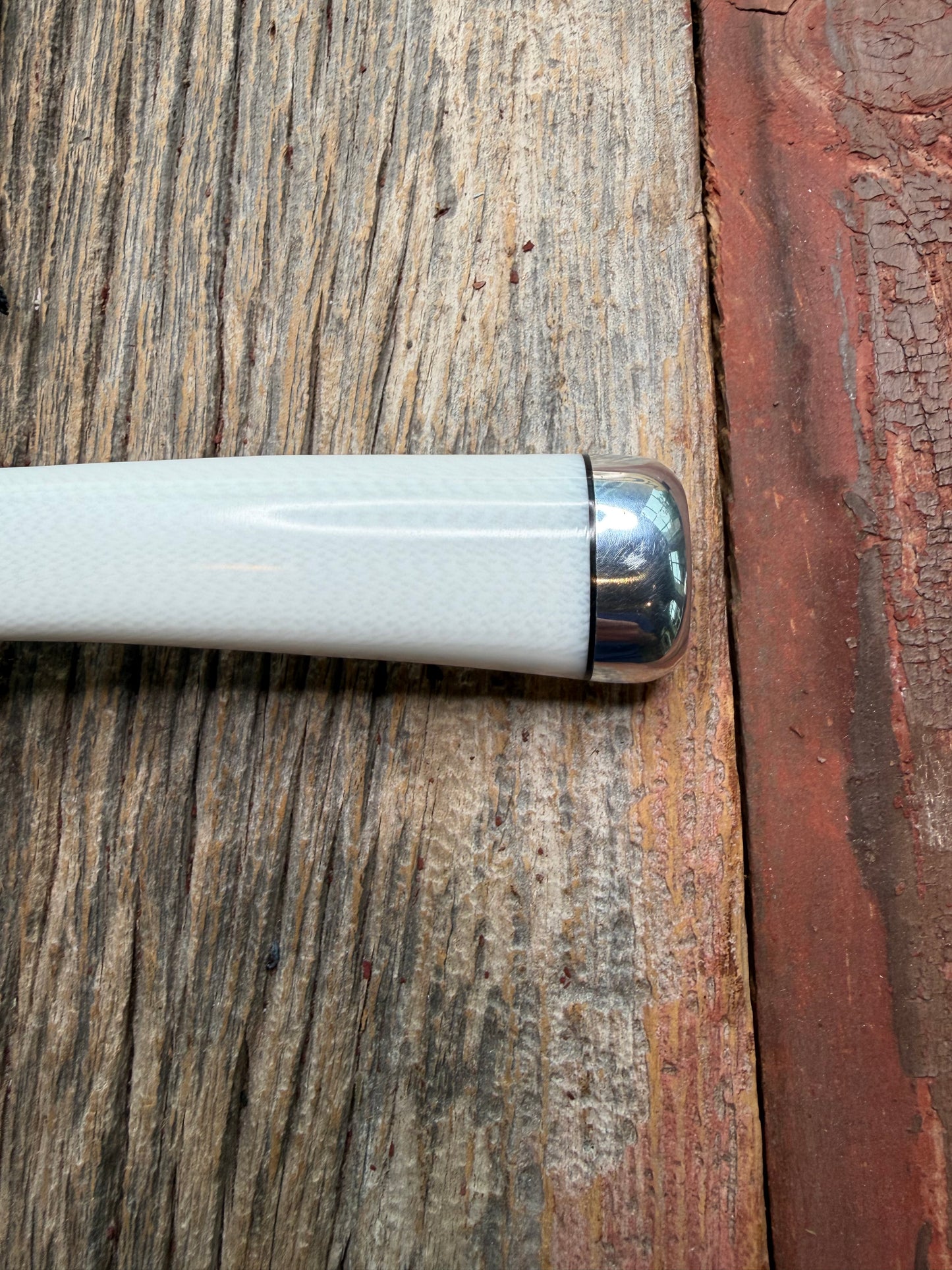 Randall Model 15 with a White Ivorite handle. Stainless steel blade, Nickel silver hilt and collar. Upgraded Black leather sheath.  Roundsd Aluminum butt cap.