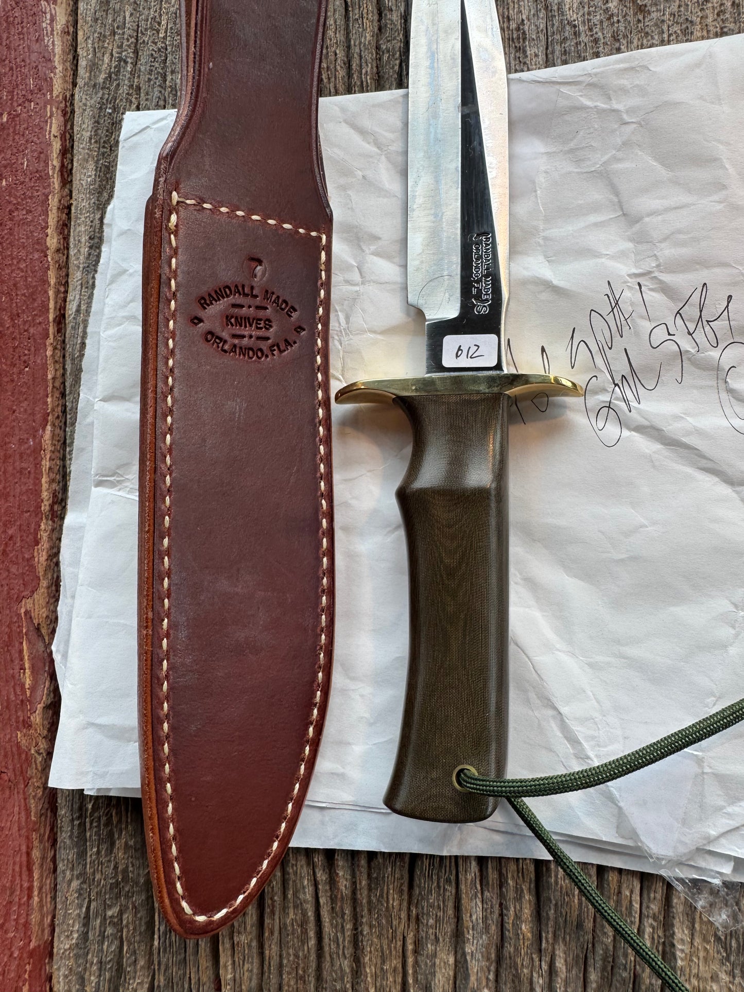 New in Paper Randall Model 16 SP#1 Special fighter with a Green Micarta handle. SS blade, Brass hilt. Lanyard. Brown leather sheath.