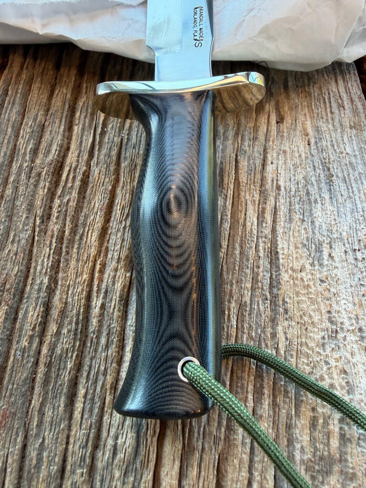 New in Paper Randall Model 16 SP#1 Special fighter with a Black Micarta handle. SS blade, Nickel silver Forward Curved hilt. Lanyard. Brown leather sheath.